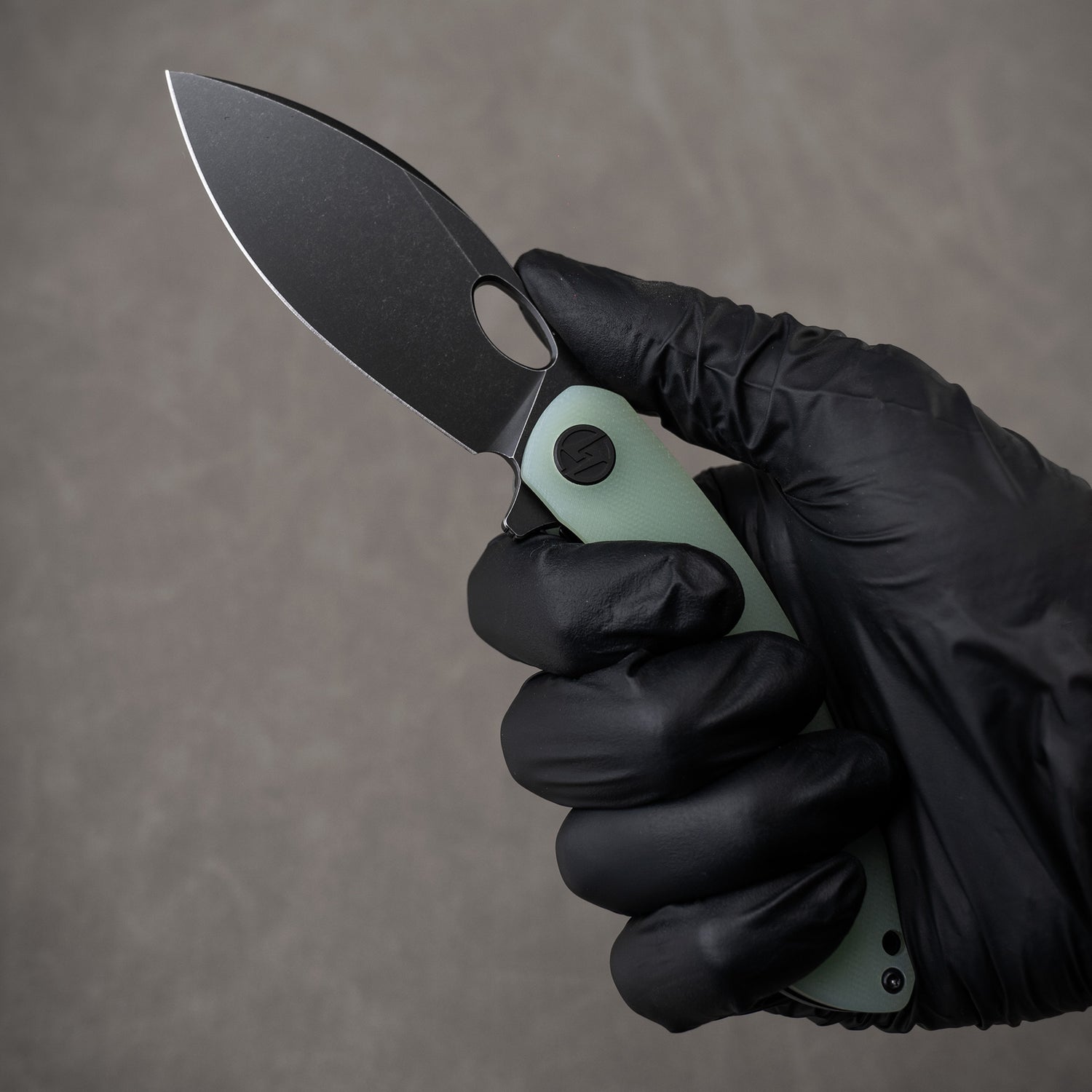 G064 in hand, open – Nature Green with black blade