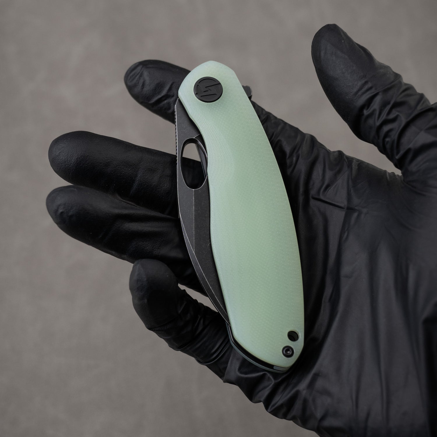 G064 in hand, closed – Nature Green and black combo