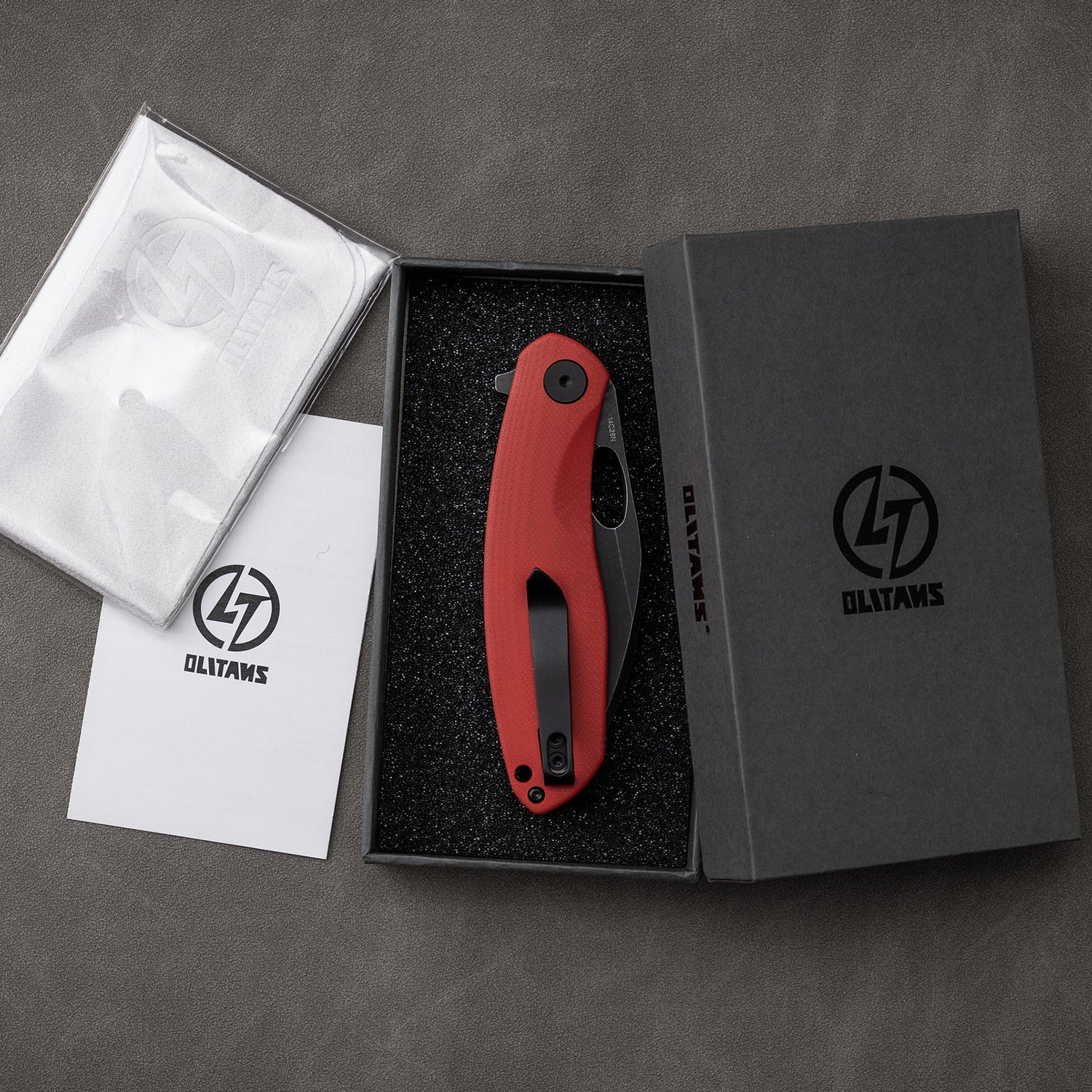 Red and black G064 folding knife inside box